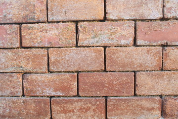 Red clay brick wall. Old eroded exterior wall. image taken with daylight