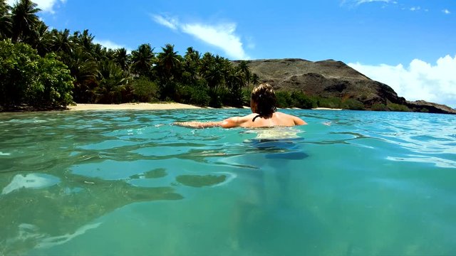 Female on a deserted Island beach Tahuata Marquesas