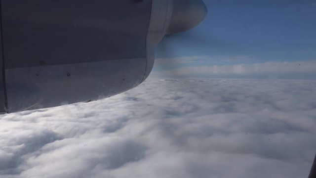 Flight on a propeller plane over the clouds