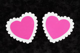 Two blank white and pink hearts on black rose textured plush fabric