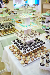 candy bar decorated by delicious sweet buffet with cupcakes and other desserts/candies,happy birthday concept