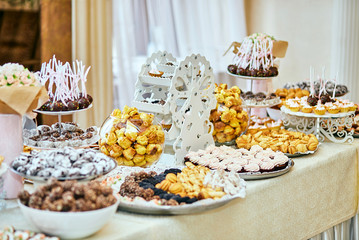 candy bar decorated by delicious sweet buffet with cupcakes and other desserts/candies,happy birthday concept