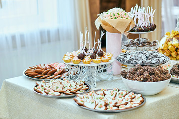 candy bar decorated by delicious sweet buffet with cupcakes and other desserts/candies,happy birthday concept