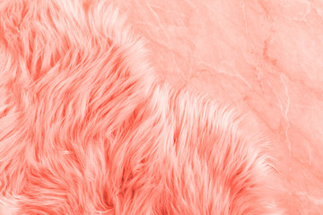 Fluffy fake textile fur. Color of the year 2019 Living Coral. Flat lay, top view, copy space