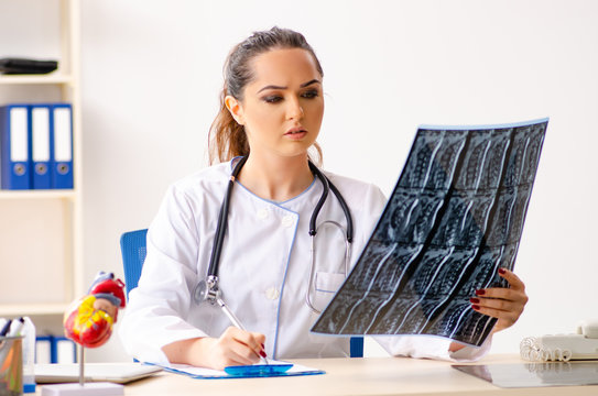 Young female doctor radiologist sitting at the clinic 