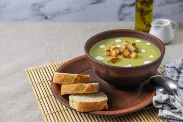 Fresh healthy cream soup with spinach, cream and croutons