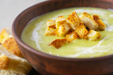 Fresh healthy cream soup with spinach, cream and croutons