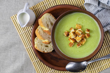 Fresh healthy cream soup with spinach, cream and croutons