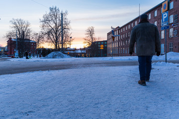 a man walking in the evening town
