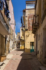Fototapeta na wymiar Colorful uphill street in Sciacca historic centre, Sicily, Italy