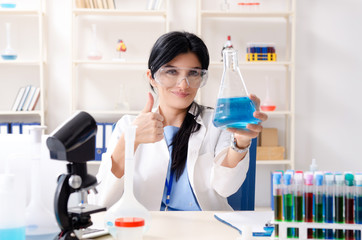 Fototapeta premium Female chemist working at the lab 
