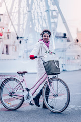 Enigmatical girl standing near her eco transport