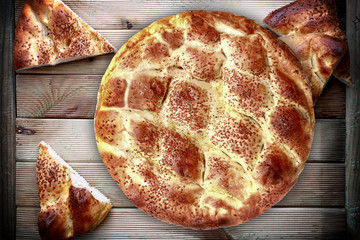 Fresh pita bread on the wood table.