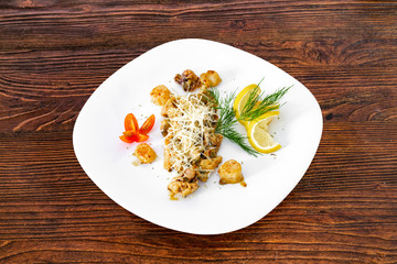 Seafood on a plate on a wooden table, a dish for the menu and advertising.