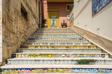 Staircase of decorated ceramic tiles leading up from the fishing port of Sciacca. Sciacca, Sicily, Agrigento province, Italy, May 2018 - obrazy, fototapety, plakaty