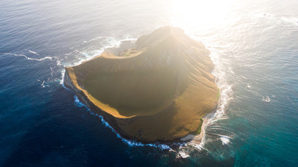 Stunning aerial drone sunrise view of Rabbit Island (Mānana Island), an uninhabited islet located...