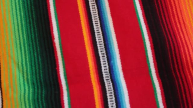 Mexican poncho rug blanket panning serape background with copy space - stock travel footage 