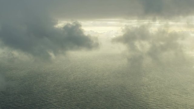 Aerial view calm ocean waters floating grey clouds 