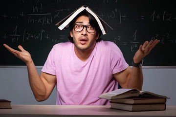 Young male student sitting in classroom