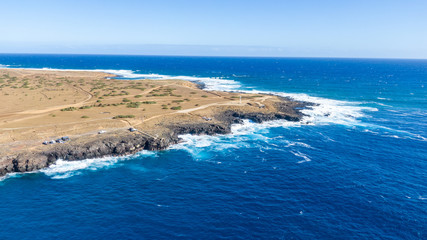 Aerial drone view of Ka Lae, known as South Point, the southernmost point of the Big Island of Hawaii and of the 50 US states. South point is a popular tourist destination with a famous cliff dive.