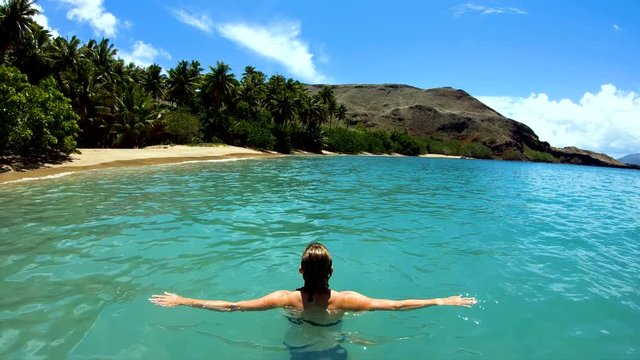 Female on a deserted Island beach Tahuata Marquesas