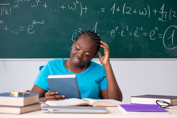 Black female student in front of chalkboard  