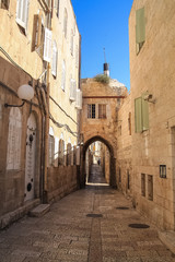 Fototapeta na wymiar Archway in Old Jerusalem city street of Jewish Quarter