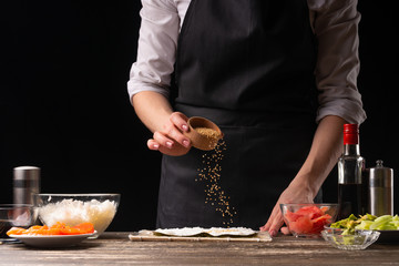 The chef prepares Japanese sushi, horizontal photo. A concept of restaurants, books of recipes, menus, delicious food