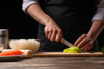 The chef prepares Japanese sushi, horizontal photo. A concept of restaurants, books of recipes, menus, delicious food