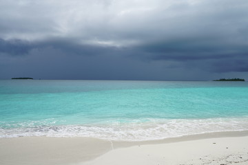Amazing turquoise water view along a beach in the Maldives during monsoon season