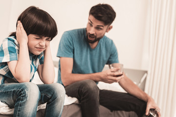 Little Boy Sitting in Room with Drunken Father.