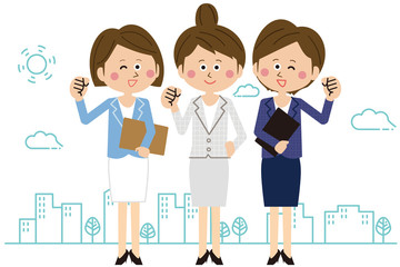 Obraz premium ポップなスーツの女性社員3人がガッツポーズ 全身 オフィス街