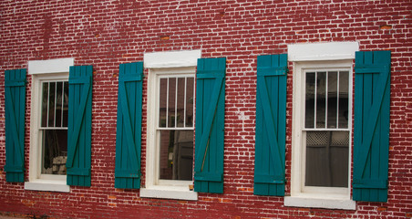 Fototapeta na wymiar Vintage Green Windows on the Red Brick Wall