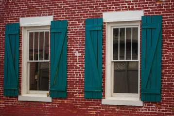 Fototapeta na wymiar Vintage Green Windows on the Red Brick Wall.