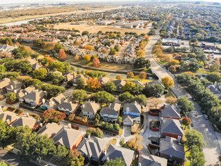 Aerial view riverside residential subdivision in fall season with colorful autumn leaves near...