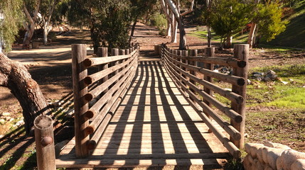 Fototapeta na wymiar Light and shadow on a wooden bridge