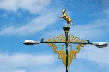 Light poles with beautiful asian-style design on the street against a blue sky