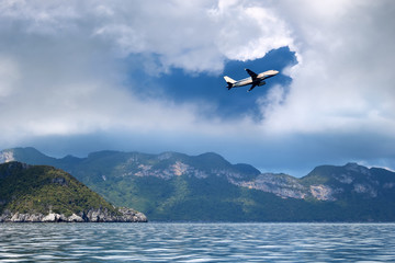 Fototapeta na wymiar Airplane in the sky with white clouds and blue sky at samui island
