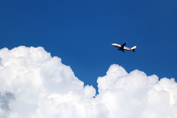 Airplane in the sky with white clouds and blue sky at samui island