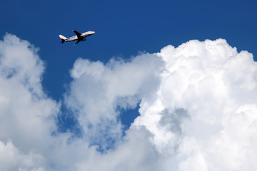 Airplane in the sky with white clouds and blue sky at samui island