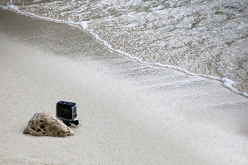 Small camera in the underwater housings set up on the beach