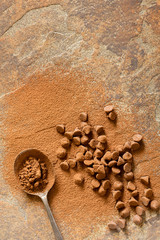 Chocolate Bits and Cocoa Powder on Stone Background Top View
