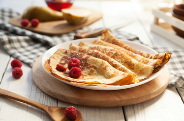 Pancakes Thin homemade pancakes with berries, traditional Russian cuisine. Homemade pancakes with...
