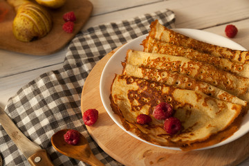 Pancakes Thin homemade pancakes with berries, traditional Russian cuisine. Homemade pancakes with berries