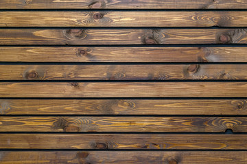 texture, background of wooden, varnished brown boards with bitches, arranged horizontally
