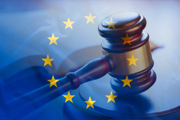 European Union flag with wooden gavel in close-up