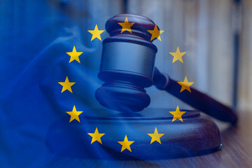 European Union flag with wooden gavel in close-up