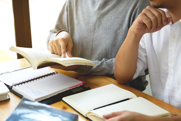 Students helps friend teaching and learning subject additional in library. Education concept.