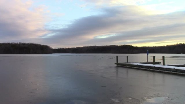 Burke Lake in Northern, Virginia is a wildlife sanctuary in the middle of a densely populated area.  This footage looks East towards the sunrise in late January.