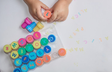 Stamps for children with the alphabet, children's pens, play on paper. Educational games for children.